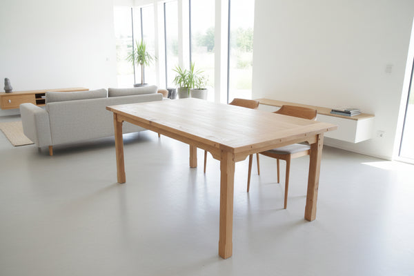 Handmade fine oak farmhouse table in modern open plan dining room