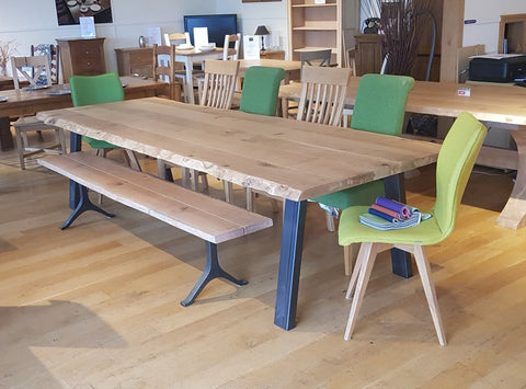 Live edge oak table on a steel base with bench and chairs