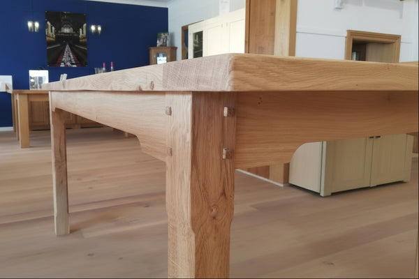 Close up of pegged through oka leg and rails of fine farmhouse table