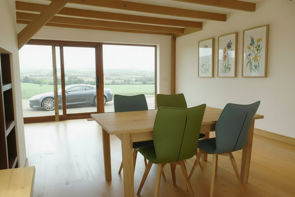 Fine oak farmhouse table in a modern farmhouse overlooking the Surrey Hills with an Aston Martin DB9 in the driveway