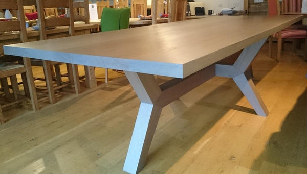 Contemporary angled oak dining table in our showroom