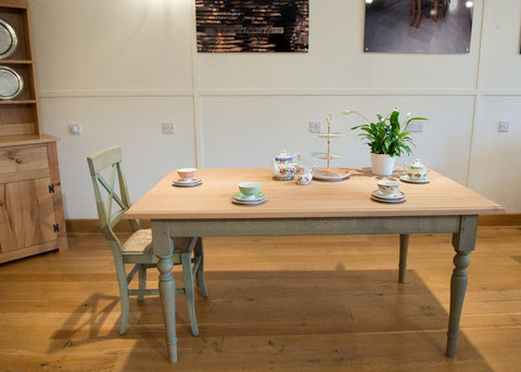 Georgian Windsor oak table with turned  lightly stained green oak base in Country Ways Oak Furniture showroom