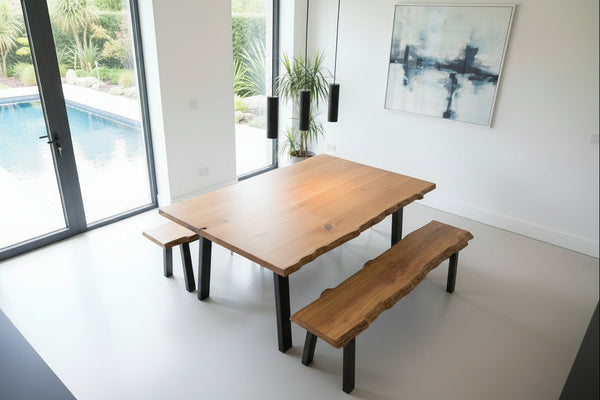 Live edge table on steel base with matching benches in a modern dining room