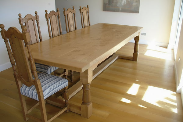 Handmade Oak Framed refectory table in a room with dining chairs