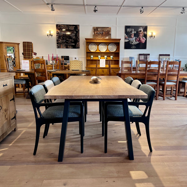 Sussex handmade oak dining table with a set of 6 chairs in our showroom end view