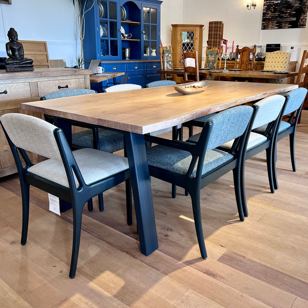 Handmade Sussex live edge oak table on a steel base with a set of chairs in our showrrom