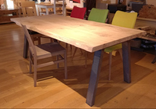 Sussex handmade live edge oak table on steel base with chairs in showroom