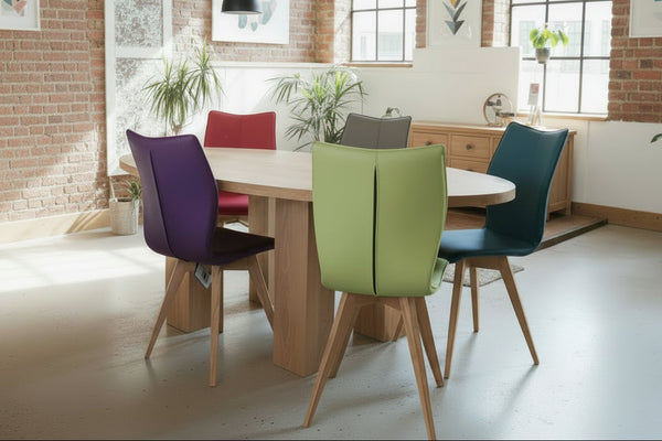 Leather Quadpod dining chairs and handmade oak oval dining table in a trendy London flat