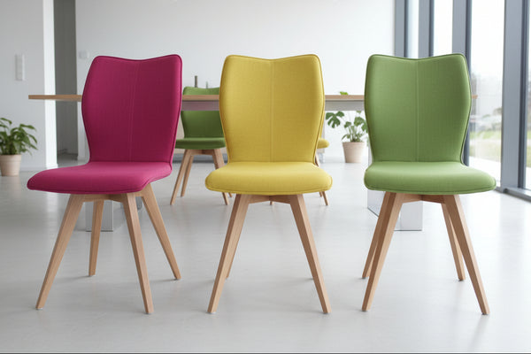 three Quadpod chairs in different colours in a modern dining room
