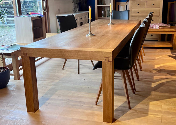 contemporary Italian extending oak dining table in a showroom setting