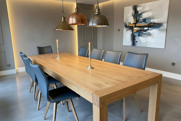 Contemporary Italian oak Terra dining table with leather upholstered Quadpod dining chairs by Country Ways Oak Furniture